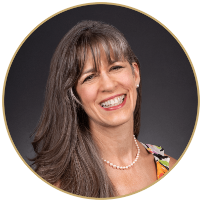 Headshot photo of Caryn Martinez. White woman with long, dark hair and bangs.